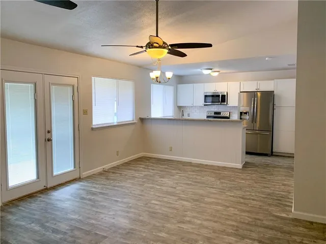 a view of a kitchen with a sink stainless steel appliances and cabinets