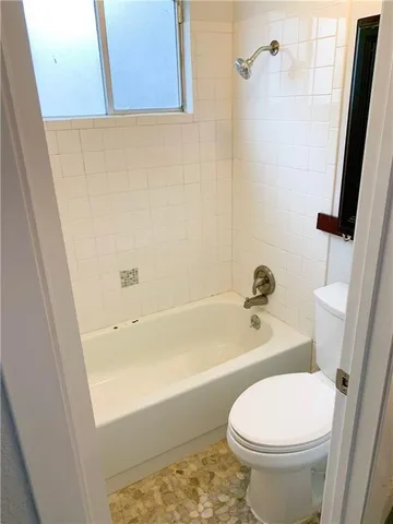 a bathroom with a toilet and a tub