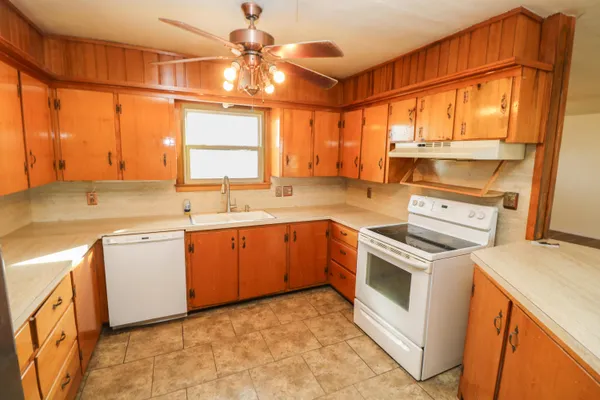 a kitchen with a stove a sink and a refrigerator