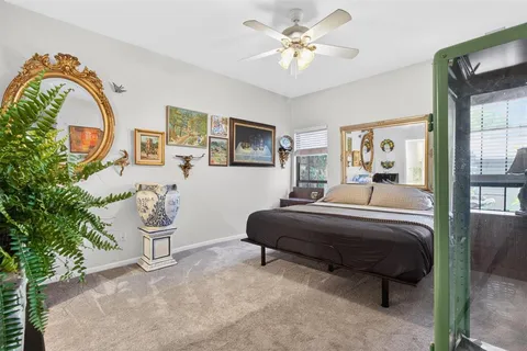 a bedroom with a bed a dresser and a large mirror