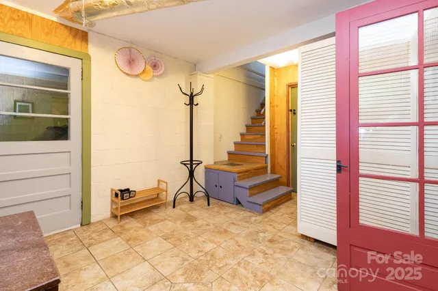 a kitchen with stainless steel appliances a refrigerator a sink a stove and white cabinets