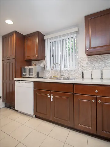 a kitchen with cabinets a sink and appliances
