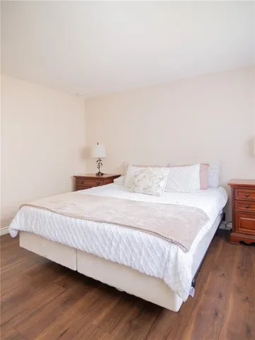 a bedroom with a bed and a night stand