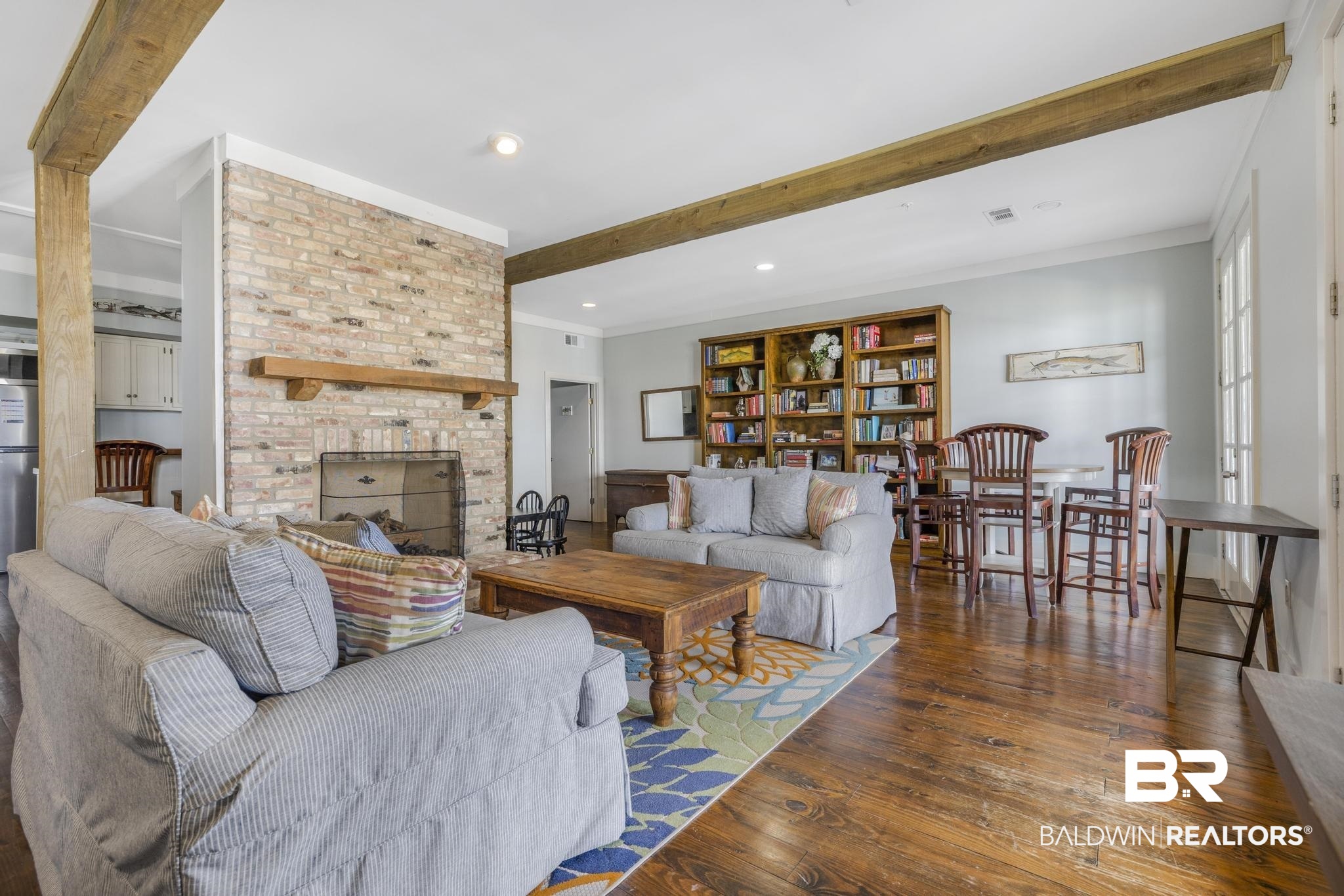 25773 Canal Road Orange Beach, AL 36561 - Photo 26 of 32 Living room with beam ceiling, hardwood / wood-style flooring, crown molding, a fireplace, and recessed lighting