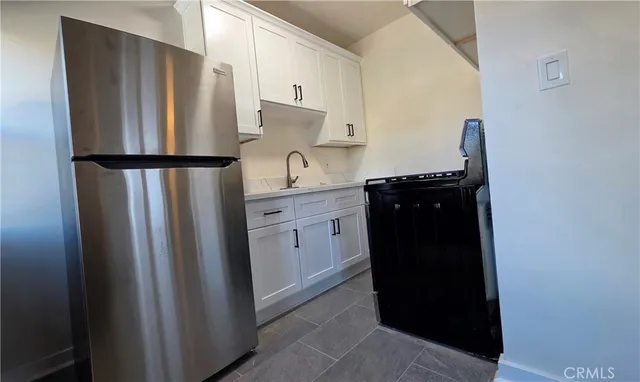 a kitchen with a refrigerator and cabinets