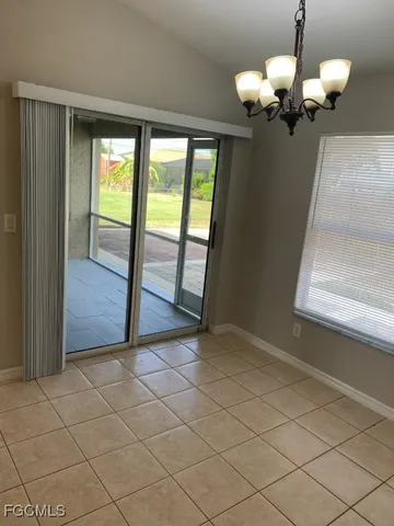 an empty room with wooden floor and mirror