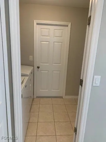 an empty room with wooden floor and entrance