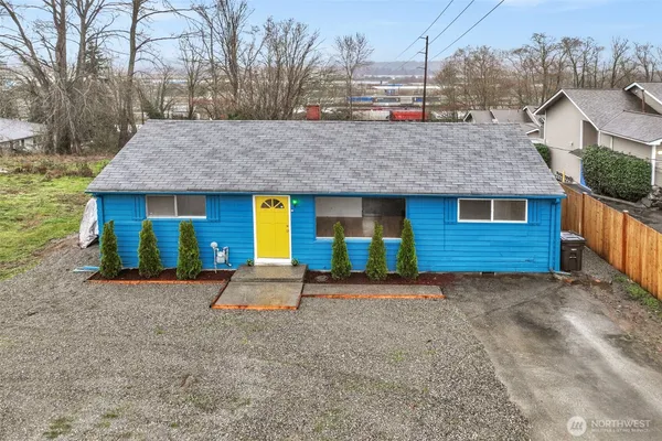 a view of a house with a yard and garage