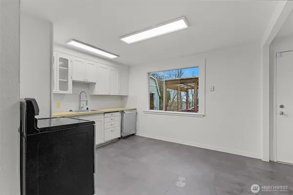 a kitchen with cabinets appliances and a sink