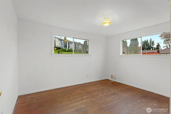 a bedroom with a bed and a potted plant