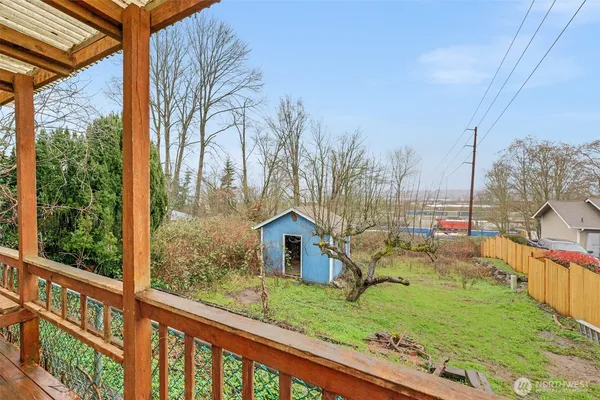 a view of a backyard with wooden fence