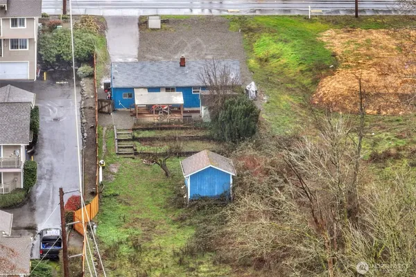 a view of a house with a yard and wooden fence
