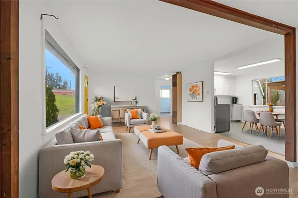 a view of a big room with wooden floor and windows
