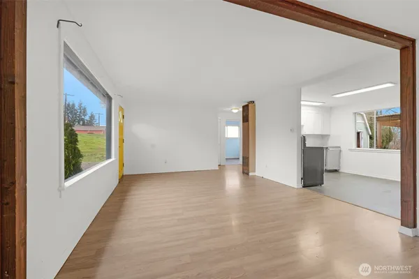 a view of empty room with wooden floor