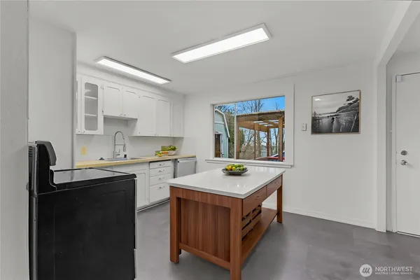 a kitchen with a sink cabinets and window