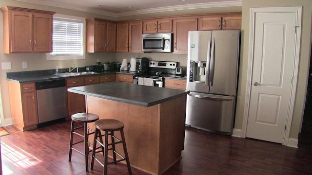 3704 Big Springs Road Lebanon, TN 37090 - Photo 3 of 20 a kitchen with stainless steel appliances granite countertop a refrigerator a stove a sink and a microwave