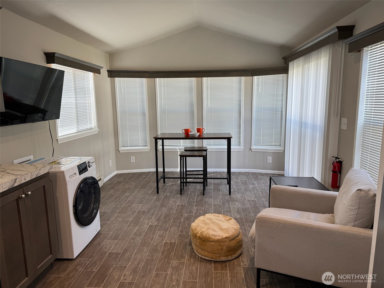 545 Hendricks Street, Unit 10A Port Townsend, WA 98368 - Photo 2 of 17 a living room with furniture a flat screen tv and a large window