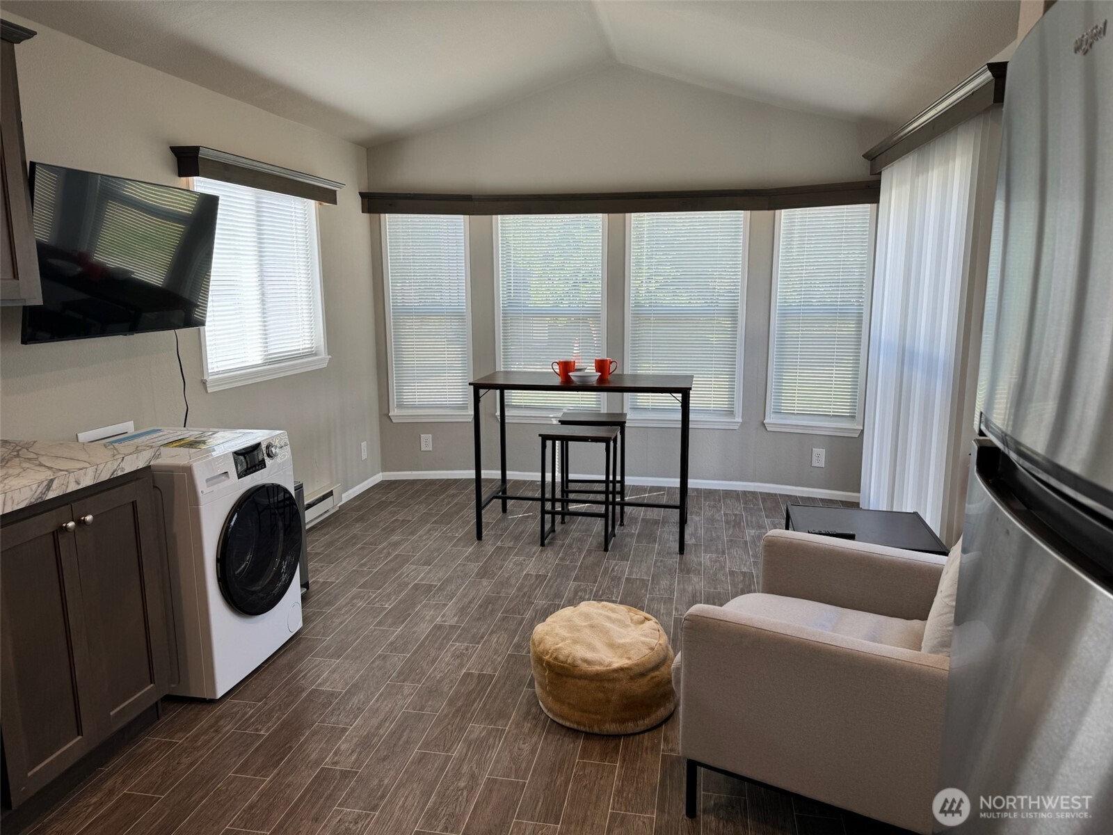 545 Hendricks Street, Unit 10A Port Townsend, WA 98368 - Photo 4 of 17 a living room with furniture and a flat screen tv