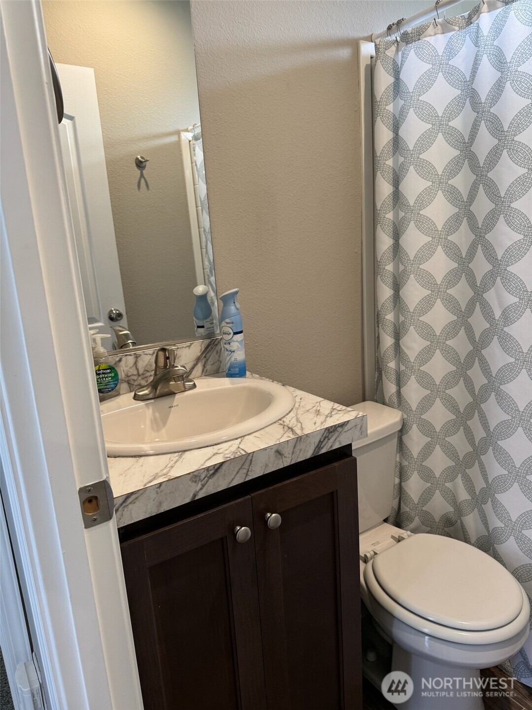 545 Hendricks Street, Unit 10A Port Townsend, WA 98368 - Photo 8 of 17 a bathroom with a granite countertop sink a toilet and a mirror