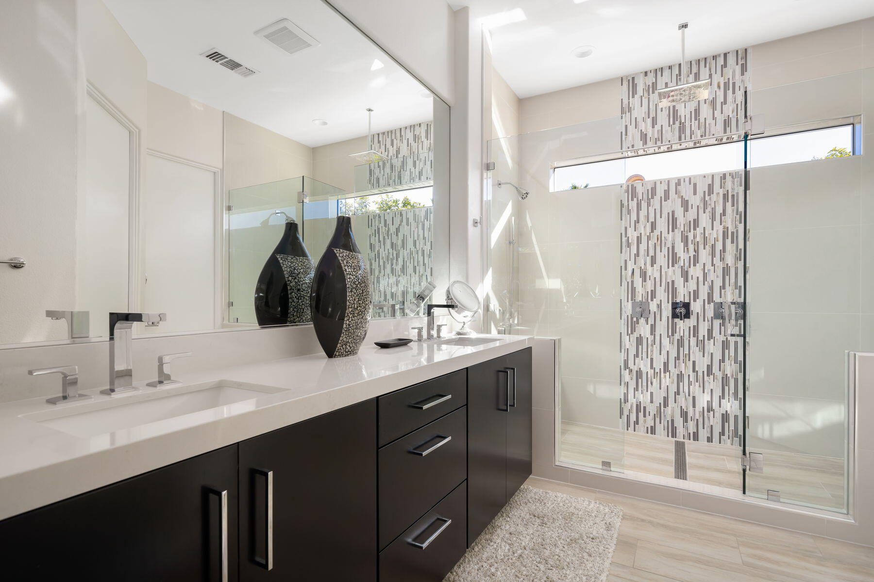 253 Loch Lomond Road Rancho Mirage, CA 92270 - Photo 19 of 66 a bathroom with a double vanity sink and mirror