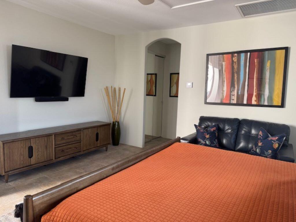 253 Loch Lomond Road Rancho Mirage, CA 92270 - Photo 26 of 66 a bedroom with bed and flat screen tv