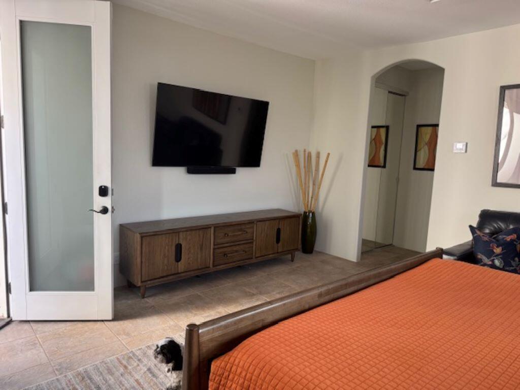 253 Loch Lomond Road Rancho Mirage, CA 92270 - Photo 27 of 66 a bedroom with a bed and a flat screen tv