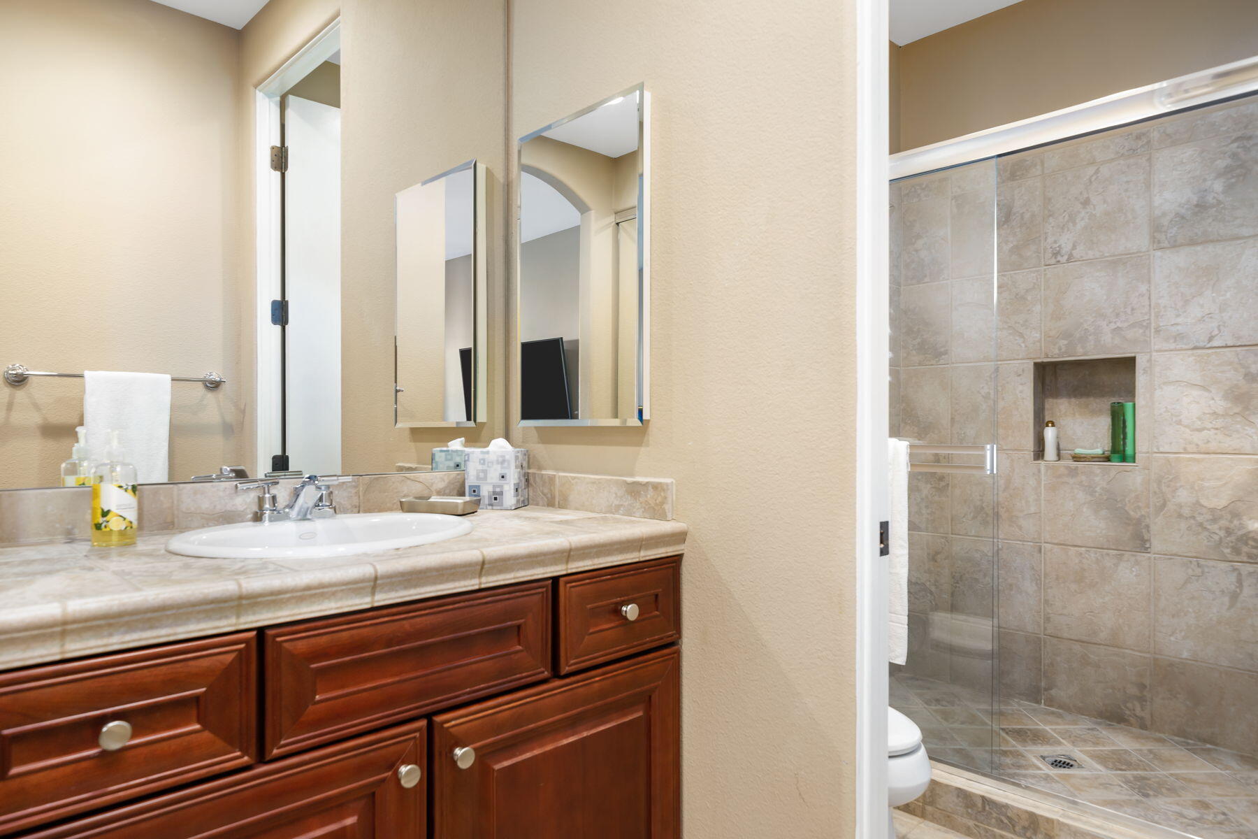 253 Loch Lomond Road Rancho Mirage, CA 92270 - Photo 28 of 66 a bathroom with a granite countertop sink and a mirror