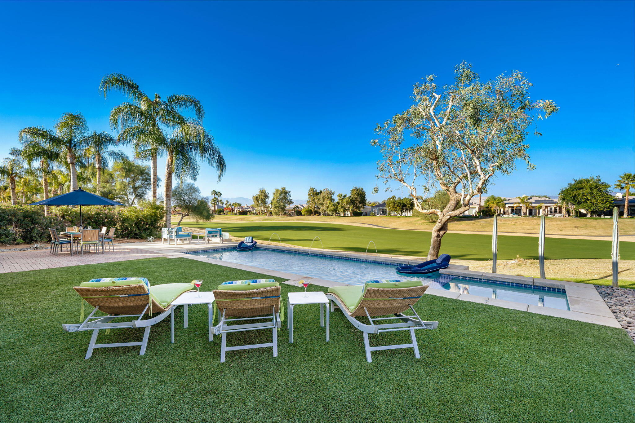 253 Loch Lomond Road Rancho Mirage, CA 92270 - Photo 33 of 66 a swimming pool with outdoor seating and yard