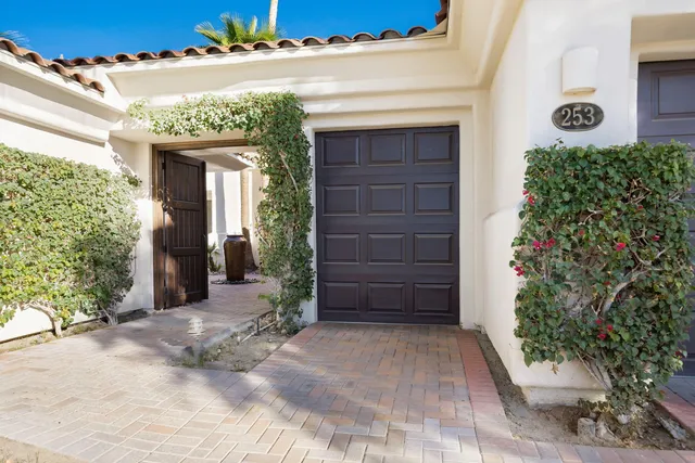 a view of a swimming pool with a garden and trees