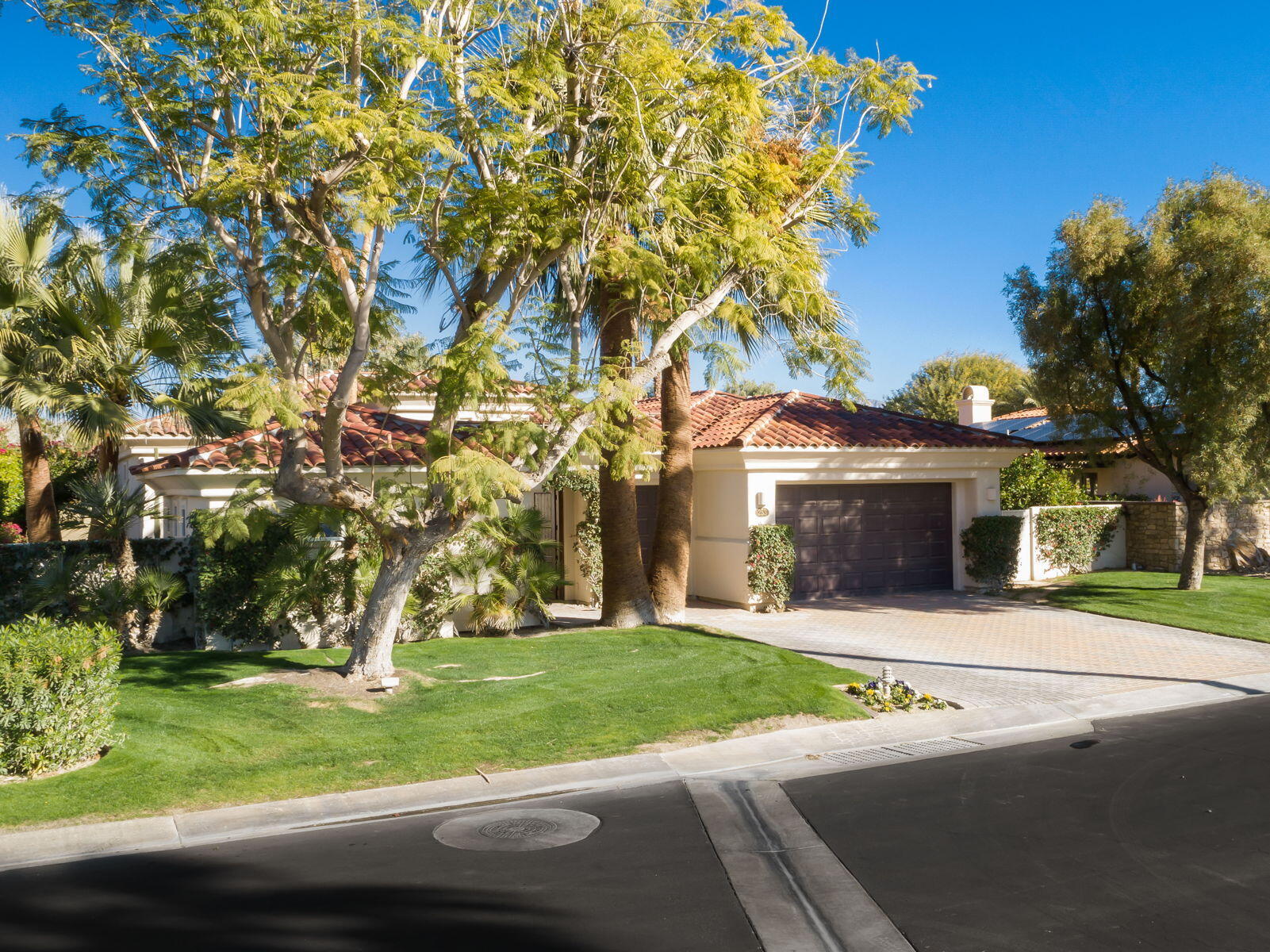 253 Loch Lomond Road Rancho Mirage, CA 92270 - Photo 51 of 66 a front view of a house with a yard and garage