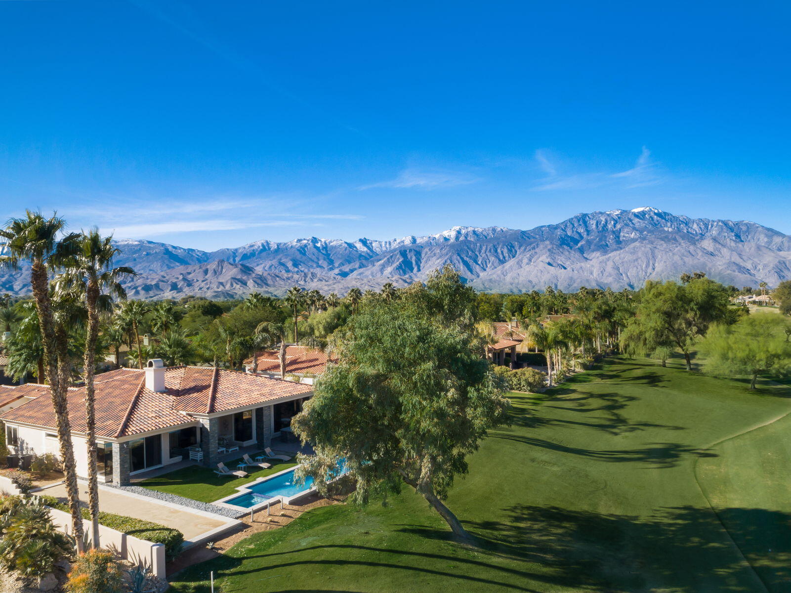 253 Loch Lomond Road Rancho Mirage, CA 92270 - Photo 56 of 66 a view of a swimming pool with a yard and mountain view