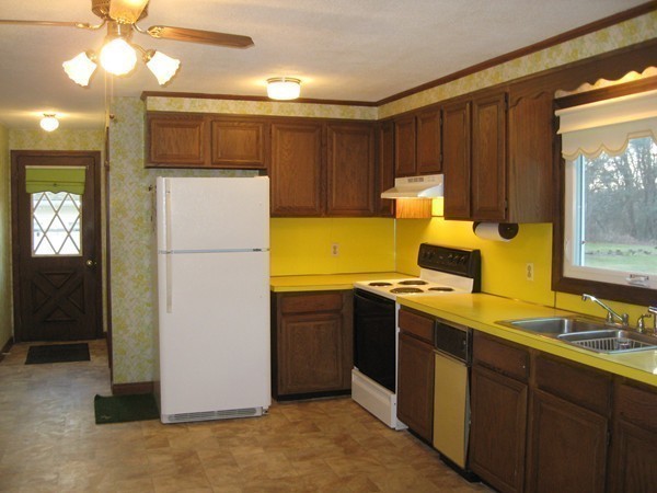 657 Amostown Road West Springfield, MA 01089 - Photo 12 of 29 a kitchen with a refrigerator and a stove