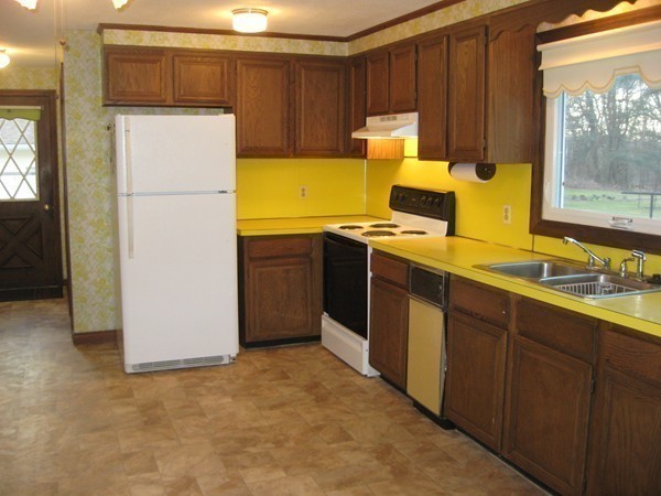 657 Amostown Road West Springfield, MA 01089 - Photo 14 of 29 a kitchen with a refrigerator sink and wooden cabinets