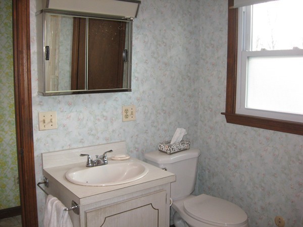 657 Amostown Road West Springfield, MA 01089 - Photo 19 of 29 a bathroom with a toilet sink and mirror