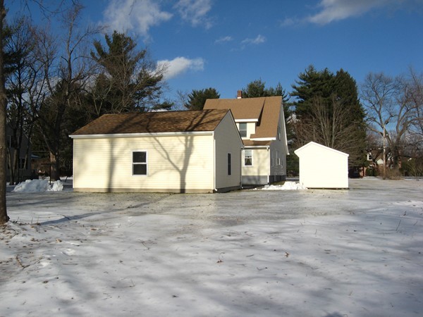 657 Amostown Road West Springfield, MA 01089 - Photo 25 of 29 a view of a white house with a yard and garage
