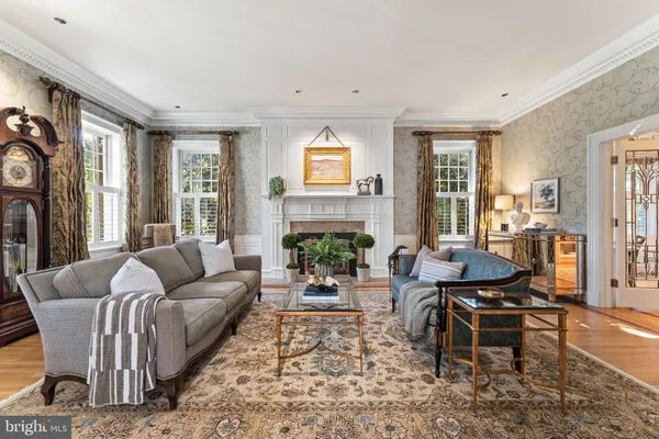 a kitchen with stainless steel appliances granite countertop a stove top oven a sink dishwasher and a fireplace with wooden floor