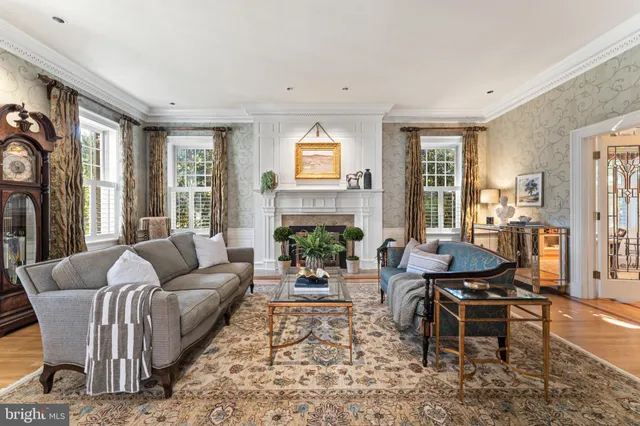 a kitchen with stainless steel appliances granite countertop a stove top oven a sink dishwasher and a fireplace with wooden floor