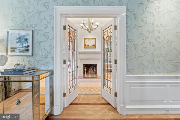 a view of a dining room with furniture a chandelier and wooden floor