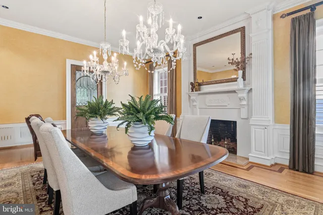 a living room with furniture large windows and a fireplace