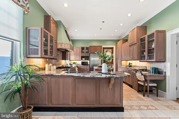 a patio with table and chairs and potted plants