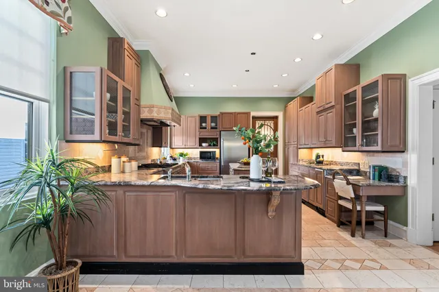 a patio with table and chairs and potted plants