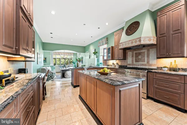 a view of a brick house with a chairs and table in a patio