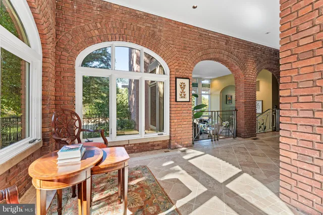 a view of a hallway with wooden floor and windows