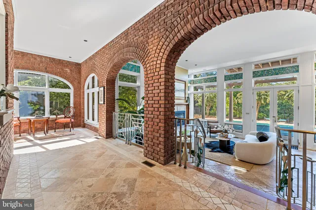 a dining room with furniture a window and a kitchen