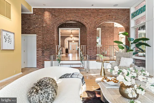 a view of a hallway with chairs and a potted plant
