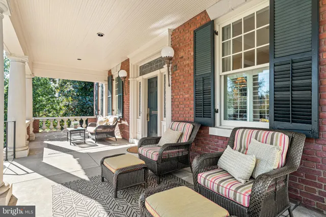 a dining room with furniture a chandelier and wooden floor