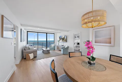 a living room with furniture and chandelier