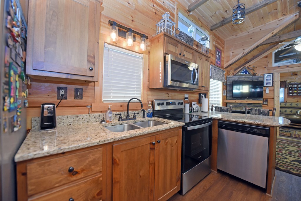 52 Foggy Mountain Road Blairsville, GA 30512 - Photo 12 of 50 a kitchen with stainless steel appliances granite countertop a sink stove and microwave