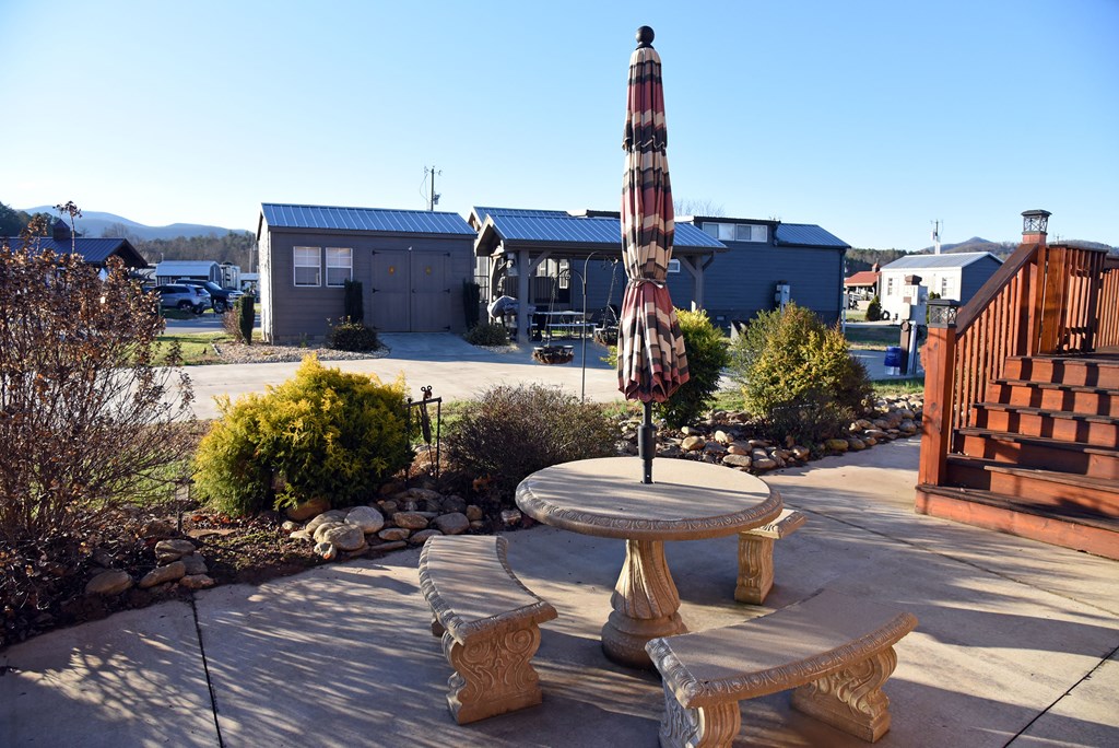 52 Foggy Mountain Road Blairsville, GA 30512 - Photo 28 of 50 a view of a patio with table and chairs potted plants