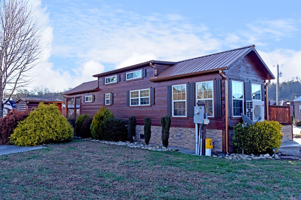 52 Foggy Mountain Road Blairsville, GA 30512 - Photo 30 of 50 a view of a brick house with a yard and plants